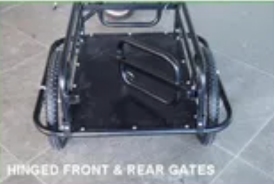 Black metal cart with hinged front and rear gates on a tiled floor.